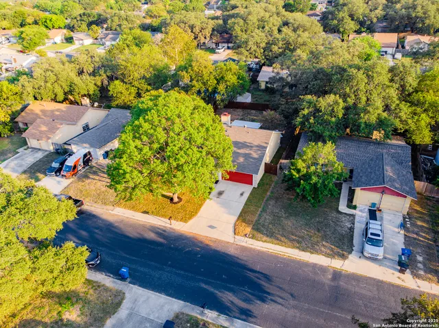 an aerial view of a house with yard swimming pool and outdoor seating