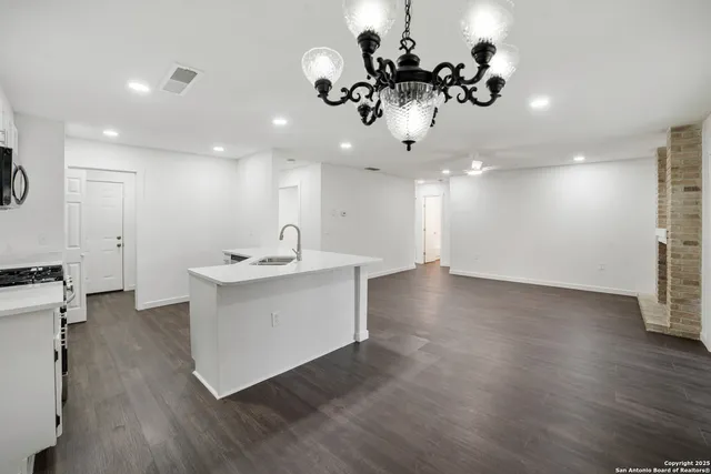 a view of a kitchen with a sink stainless steel appliances and cabinets