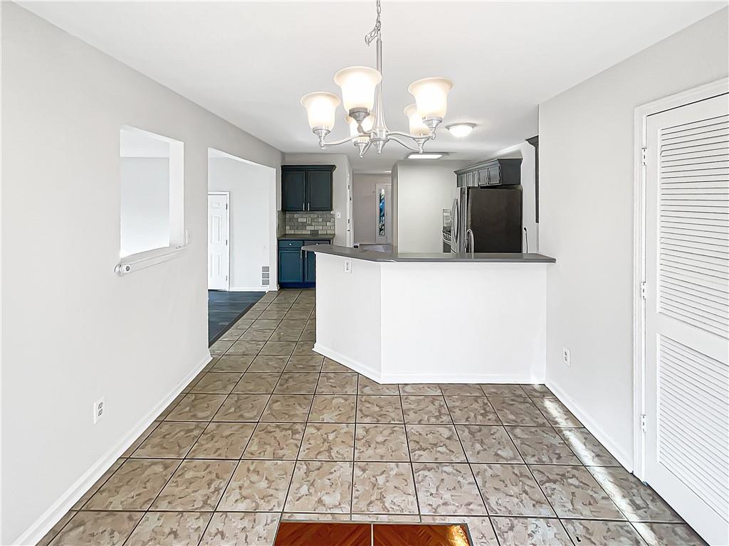 2867 Oakvale Falls Drive Decatur, GA 30034 - Photo 11 of 26 a view of a big room with chandelier fan and kitchen view