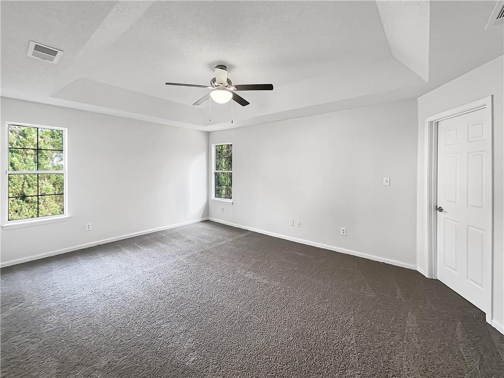 2867 Oakvale Falls Drive Decatur, GA 30034 - Photo 13 of 26 an empty room with windows and fan