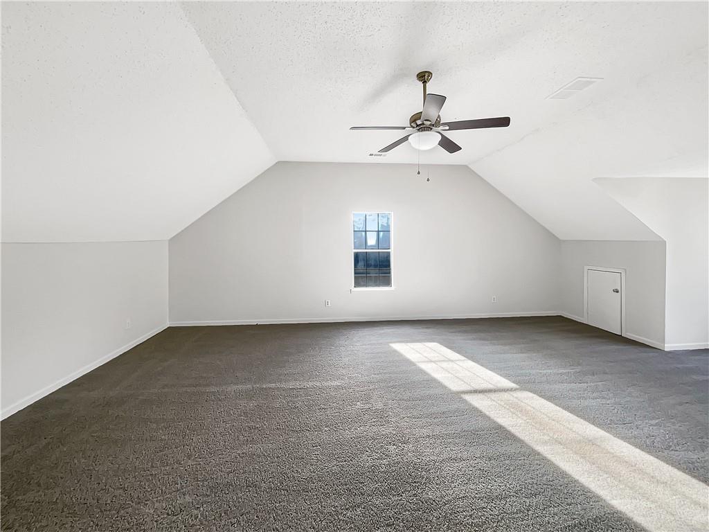 2867 Oakvale Falls Drive Decatur, GA 30034 - Photo 15 of 26 an empty room with a ceiling fan and a window