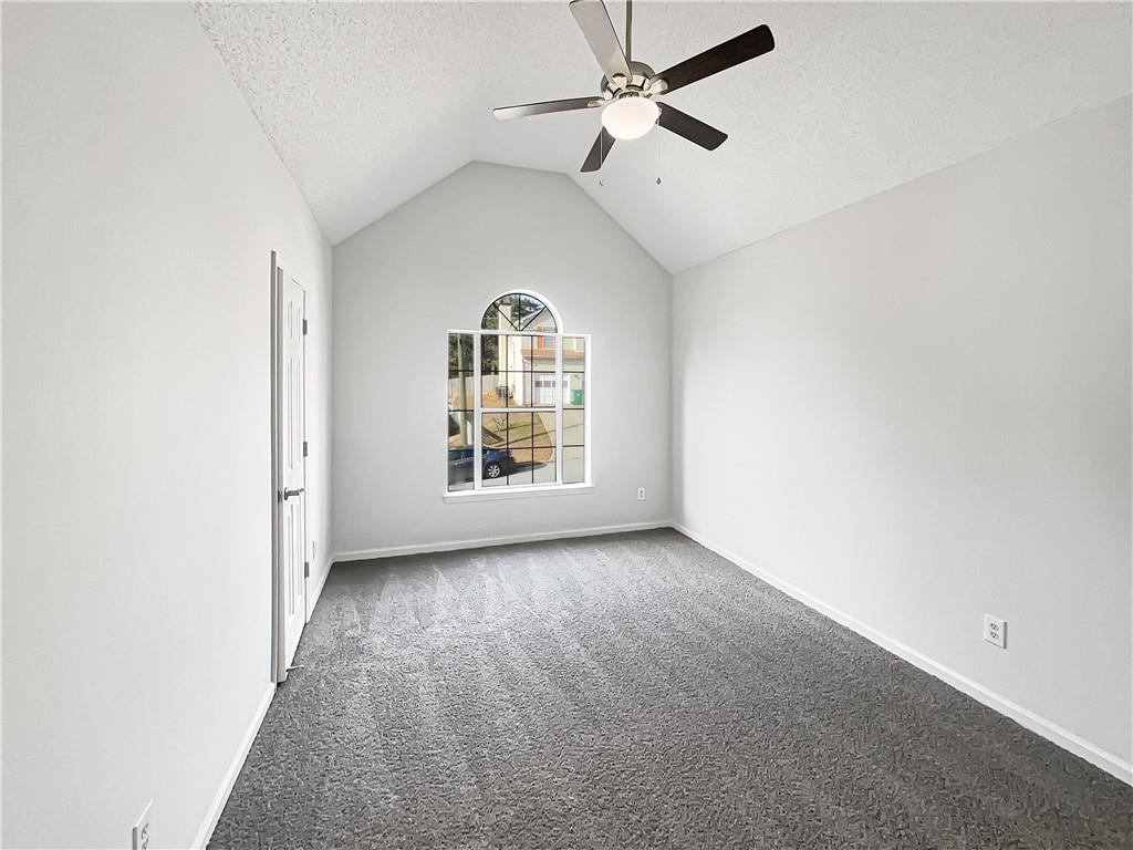 2867 Oakvale Falls Drive Decatur, GA 30034 - Photo 16 of 26 an empty room with windows and ceiling fan