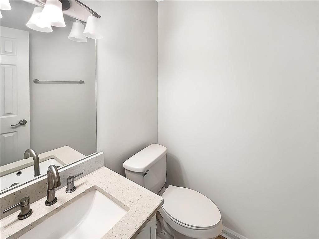 2867 Oakvale Falls Drive Decatur, GA 30034 - Photo 20 of 26 a white toilet sitting next to a bathroom sink
