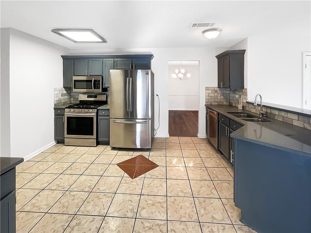 2867 Oakvale Falls Drive Decatur, GA 30034 - Photo 2 of 26 a kitchen with stainless steel appliances granite countertop a refrigerator and a stove top oven