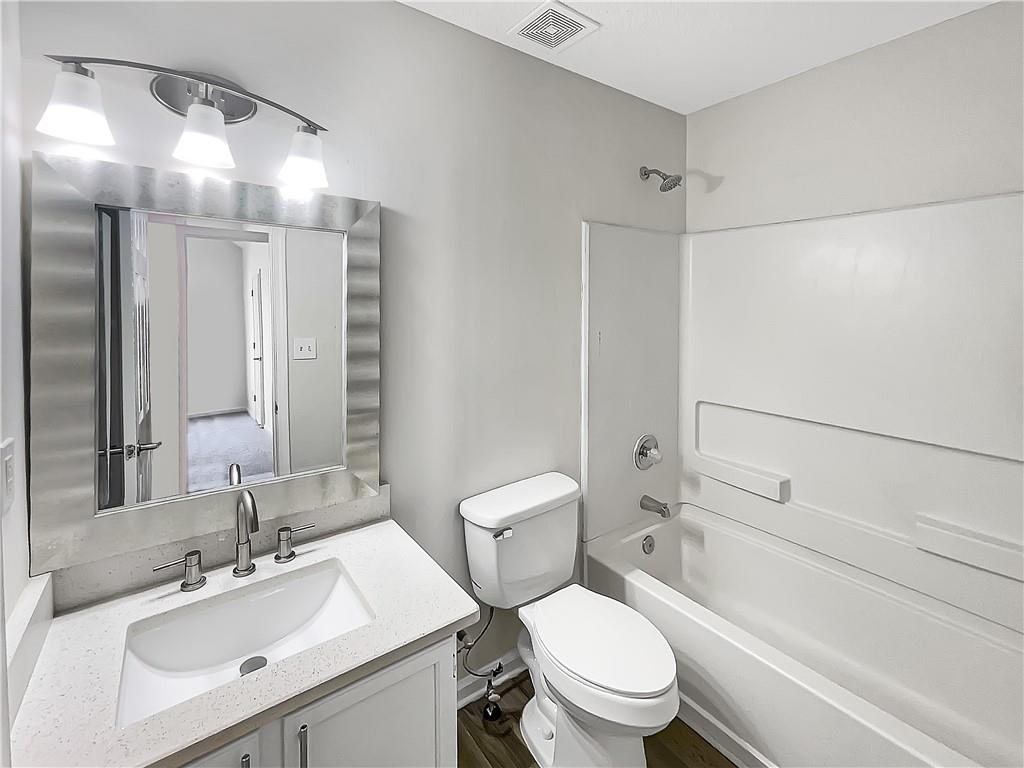2867 Oakvale Falls Drive Decatur, GA 30034 - Photo 21 of 26 a bathroom with a sink toilet vanity and shower