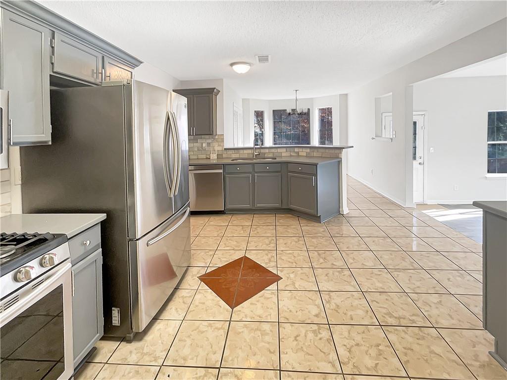 2867 Oakvale Falls Drive Decatur, GA 30034 - Photo 3 of 26 a kitchen with stainless steel appliances a refrigerator sink and cabinets