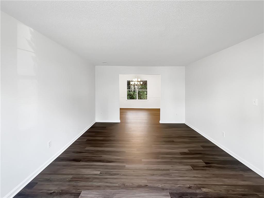 2867 Oakvale Falls Drive Decatur, GA 30034 - Photo 8 of 26 a view of an empty room with wooden floor and a window