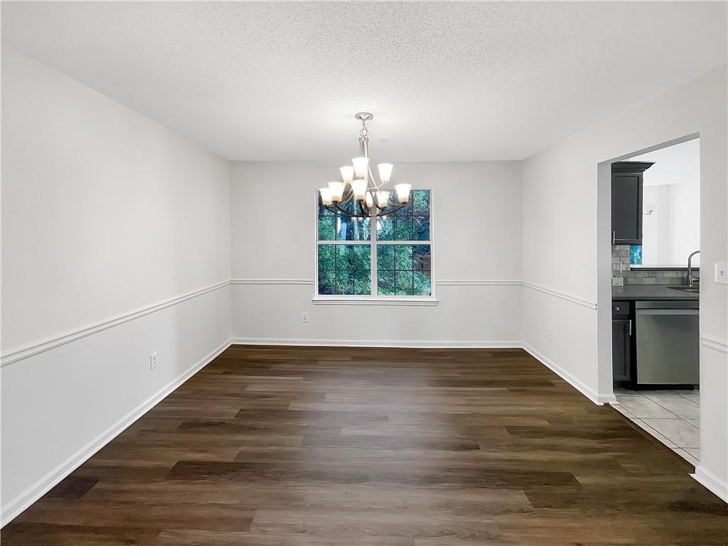 2867 Oakvale Falls Drive Decatur, GA 30034 - Photo 9 of 26 a view of an empty room with window and wooden floor