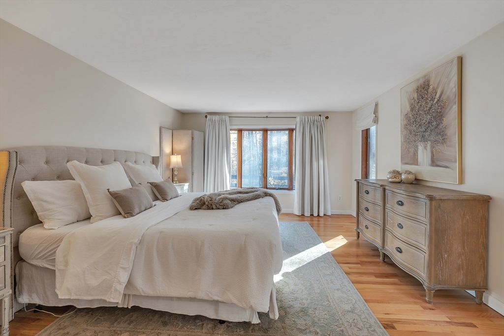62 Coal Kiln Road Princeton, MA 01541 - Photo 20 of 41 a spacious bedroom with a bed and large windows