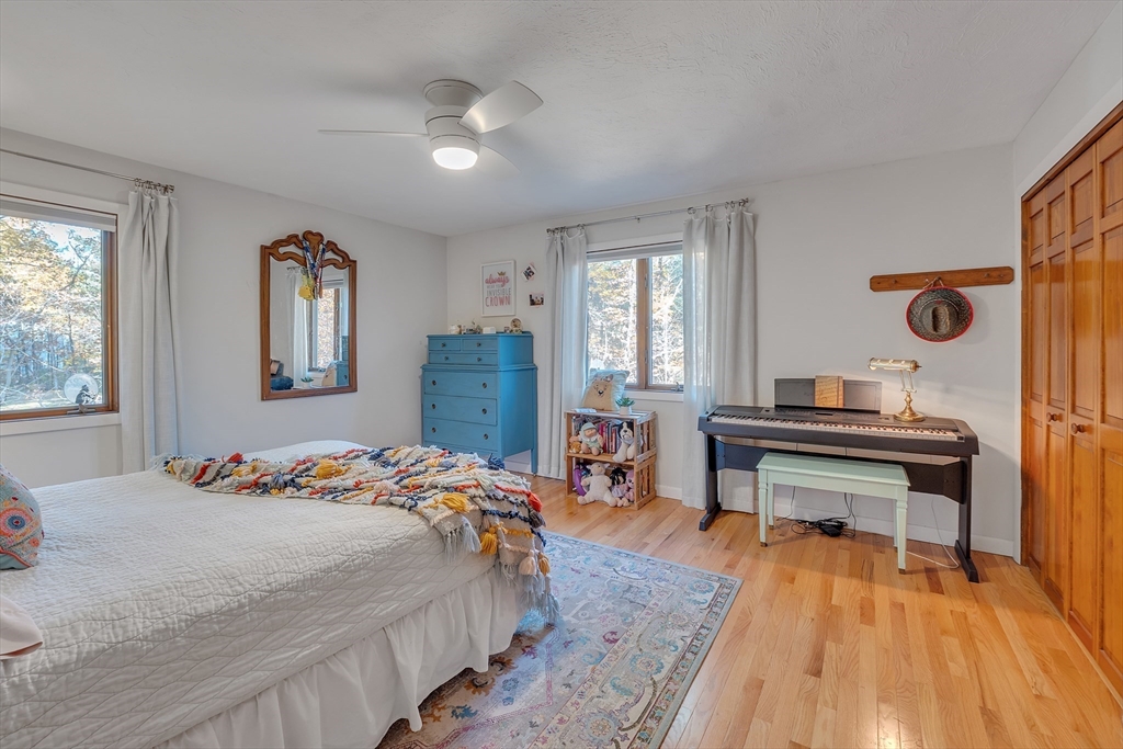 62 Coal Kiln Road Princeton, MA 01541 - Photo 28 of 41 a bedroom with a bed and wooden floor