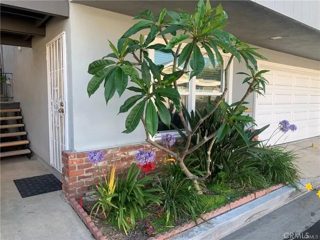 a vase of flowers sitting on a wooden floor