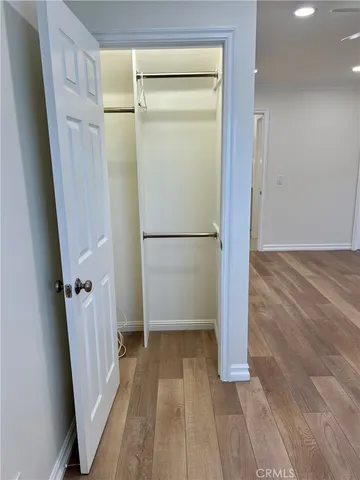 a view of a room with wooden floor and a hallway