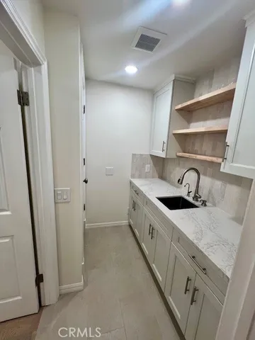 a kitchen with stainless steel appliances granite countertop a sink and a stove top oven