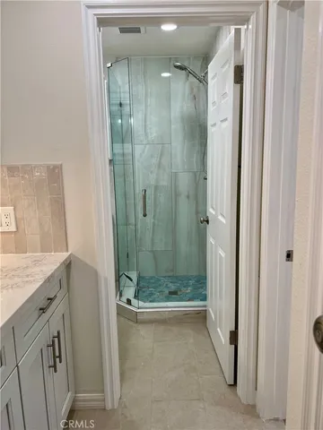 a bathroom with a shower and a sink