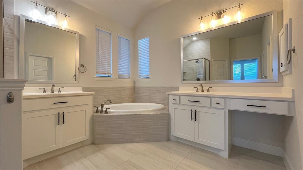 5304 Babcock Road McKinney, TX 75071 - Photo 21 of 27 a bathroom with a sink double vanity mirror and a bathtub