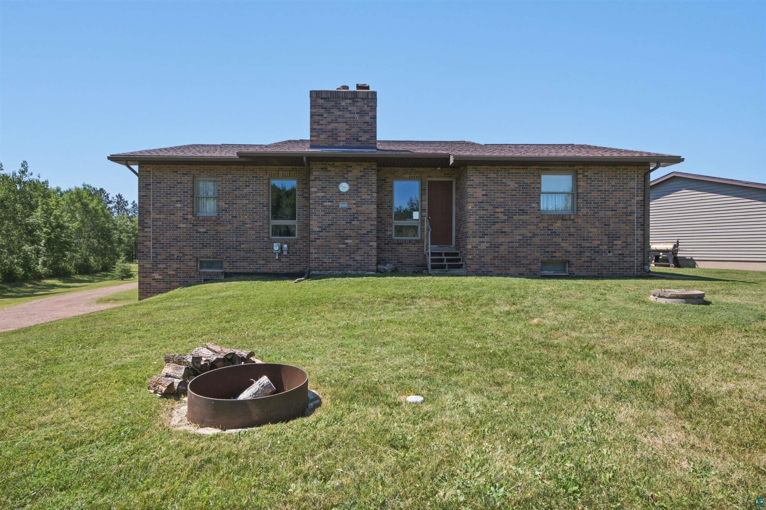 64260 Jolma Road Ashland, WI 54806 - Photo 4 of 35 Brick exterior residence featuring a prominent central chimney
