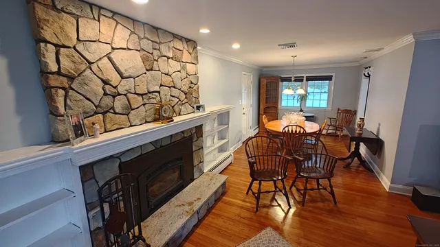 a view of a dining room with furniture and wooden floor