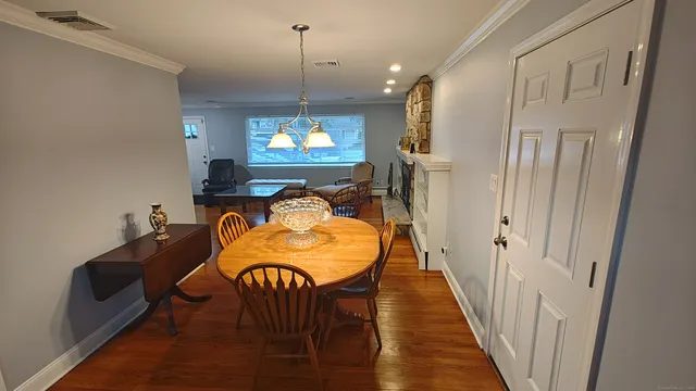 a view of a dining room with furniture and a chandelier