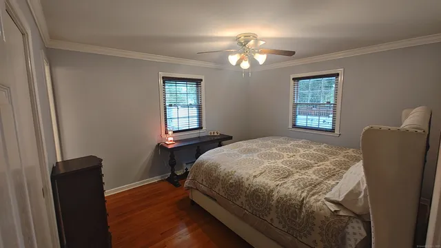 a bedroom with a bed and wooden floor