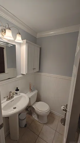 a bathroom with a sink mirror and toilet