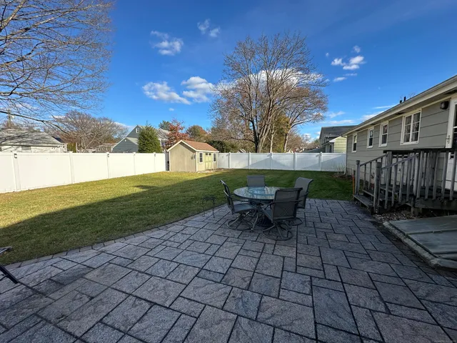 a view of a backyard with sitting area
