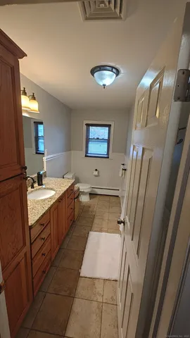 a large bathroom with a double vanity sink a mirror and a bathtub