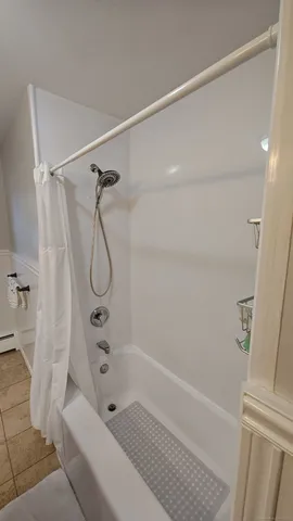 a bathroom with a bathtub and shower