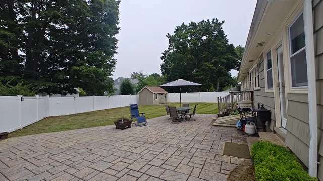 a swimming pool with outdoor seating and yard