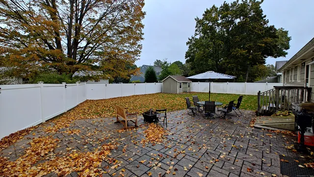 an outdoor space with seating area and trees