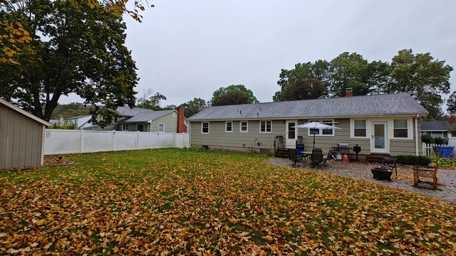 a view of a house with a large tree in front of it