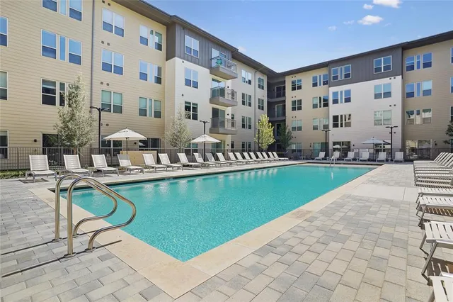 a swimming pool with outdoor seating and yard