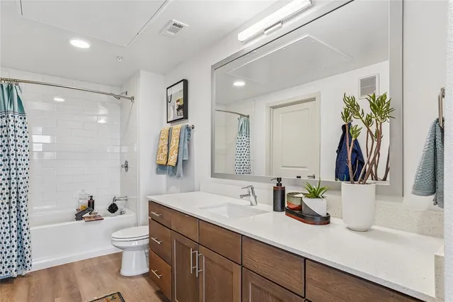 a bathroom with a sink a toilet and a large mirror