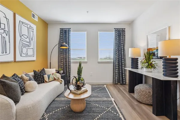 a living room with furniture and a potted plant