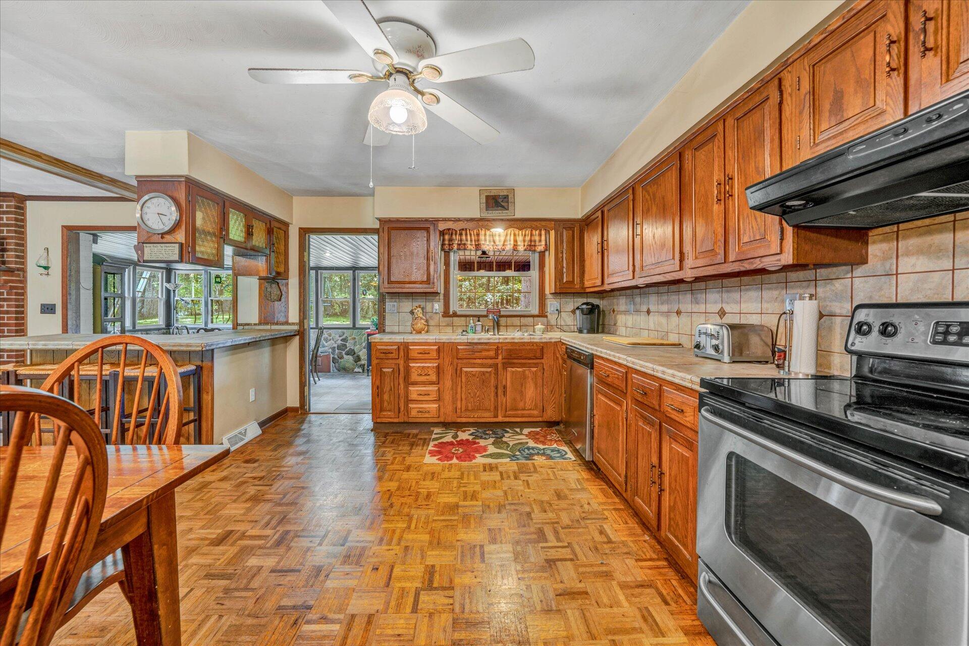 1182 Rabbit Drive Thaxton, VA 24174 - Photo 11 of 58 a kitchen with stainless steel appliances granite countertop a stove top oven a sink a counter space and cabinets