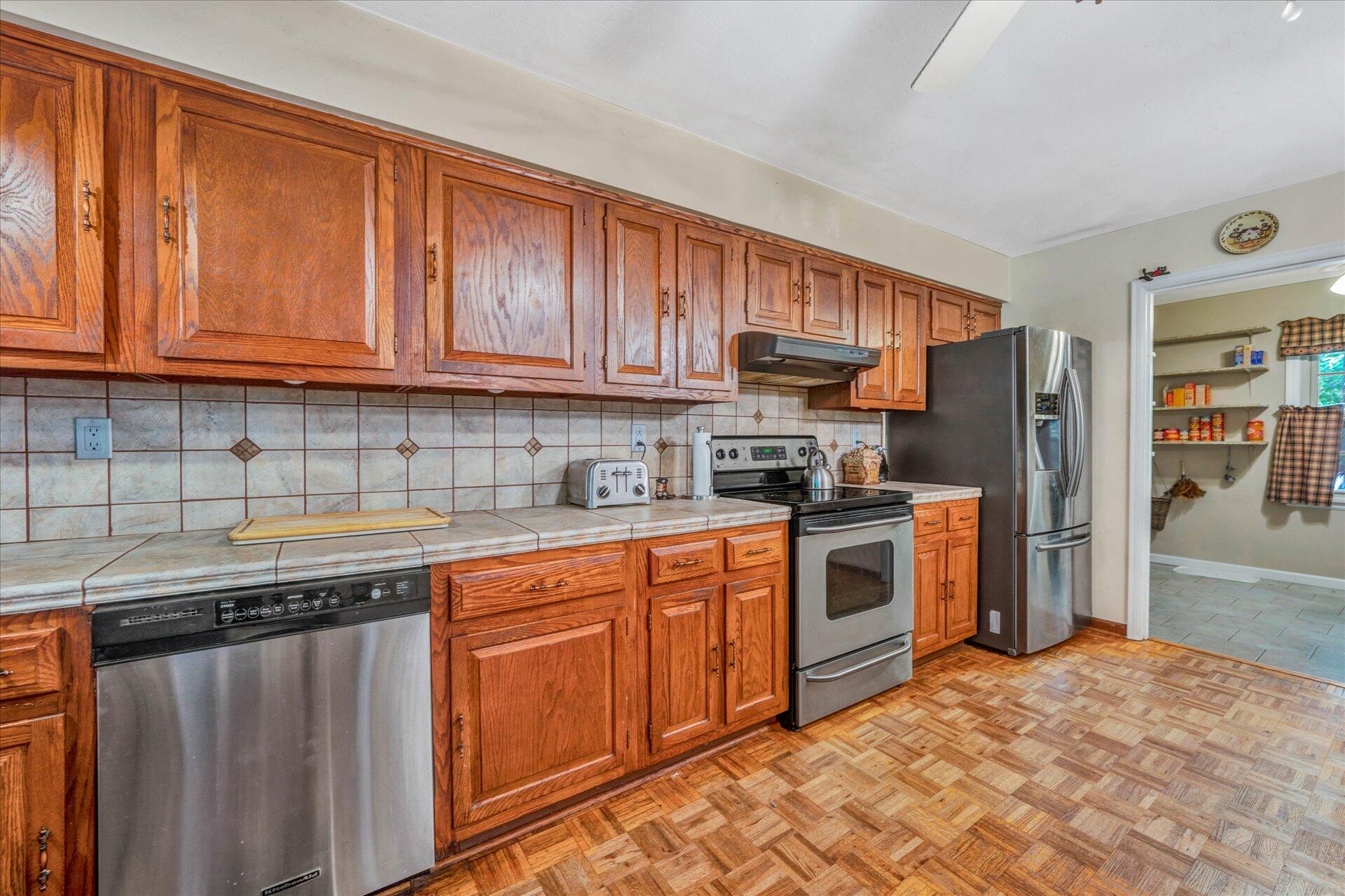 1182 Rabbit Drive Thaxton, VA 24174 - Photo 13 of 58 a kitchen with stainless steel appliances granite countertop a stove sink and cabinets