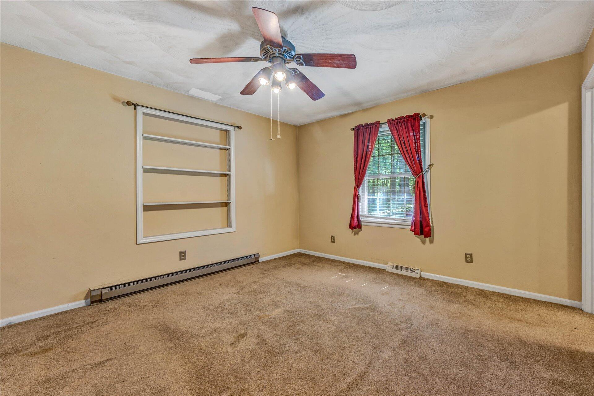 1182 Rabbit Drive Thaxton, VA 24174 - Photo 17 of 58 an empty room with windows and fan