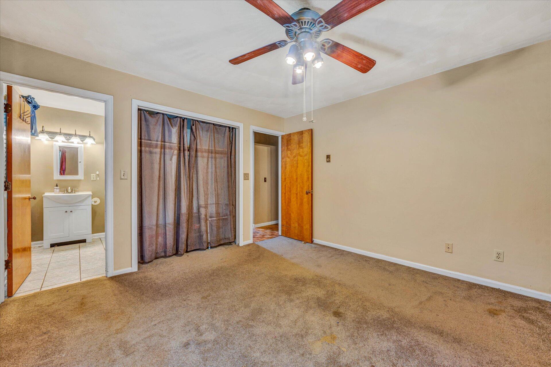 1182 Rabbit Drive Thaxton, VA 24174 - Photo 18 of 58 a view of a big room with windows and a chandelier fan