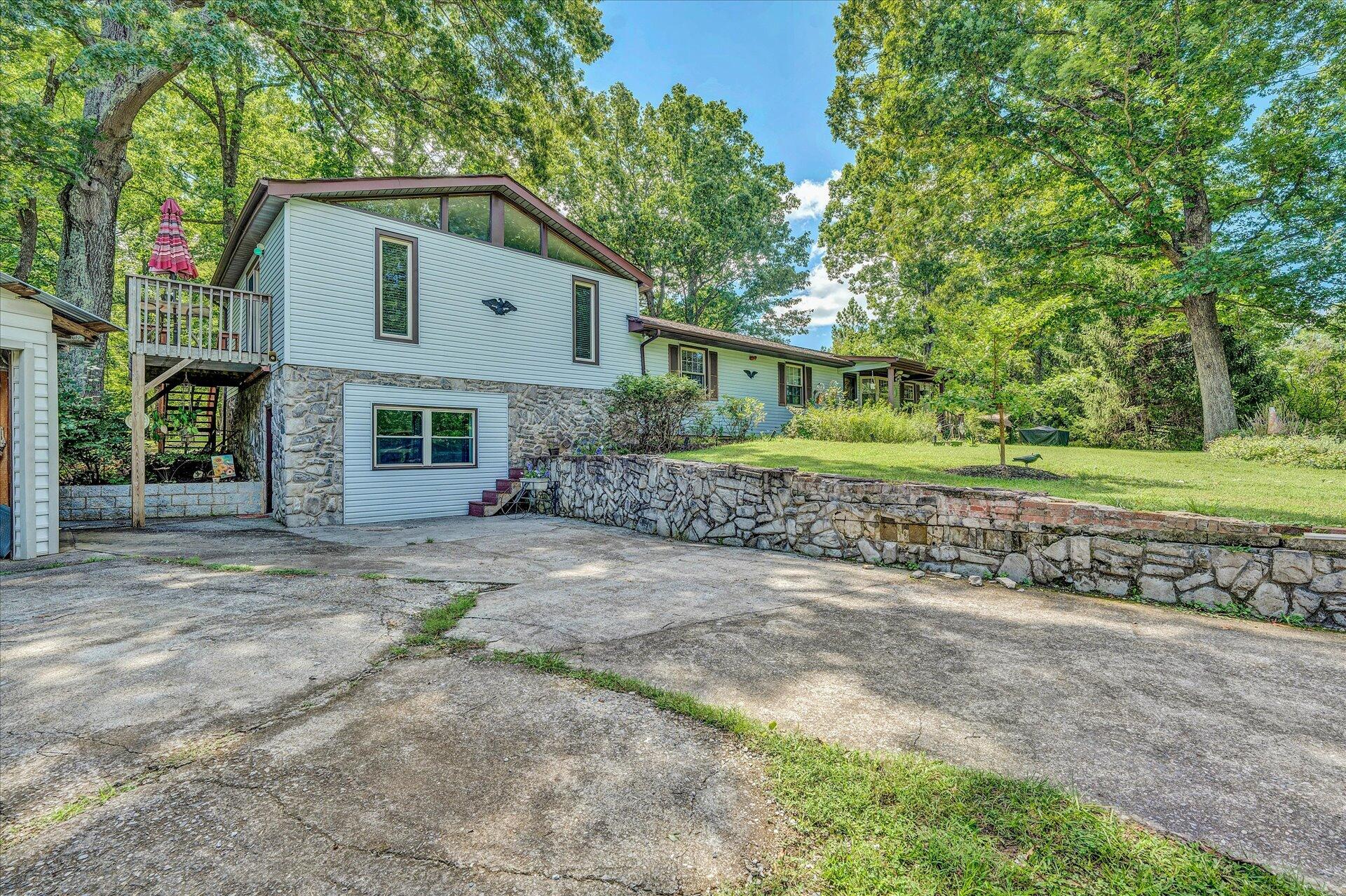 1182 Rabbit Drive Thaxton, VA 24174 - Photo 4 of 58 a front view of a house with a yard and garage