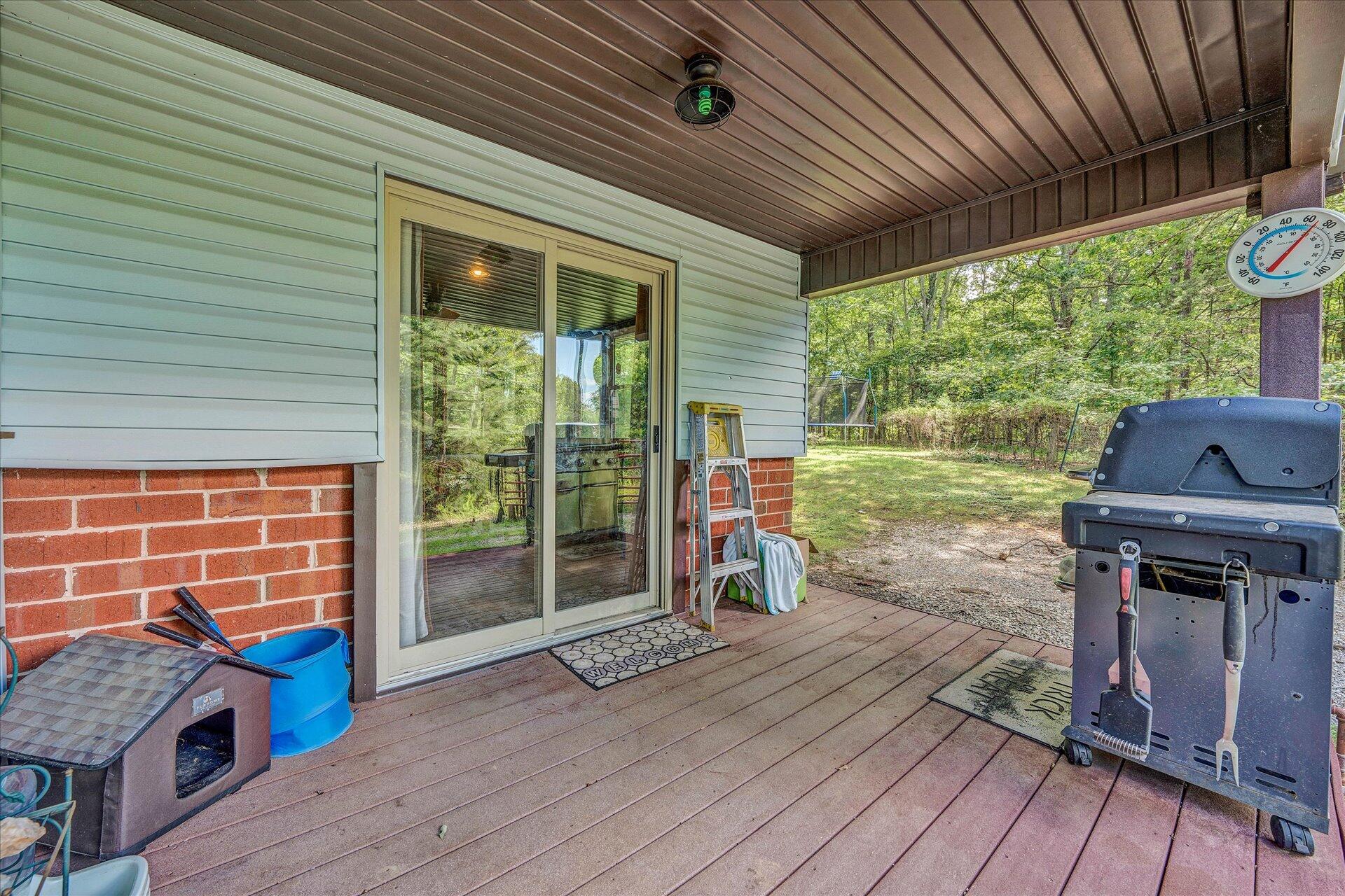 1182 Rabbit Drive Thaxton, VA 24174 - Photo 42 of 58 a view of a deck with wooden floor and roof with a garden view