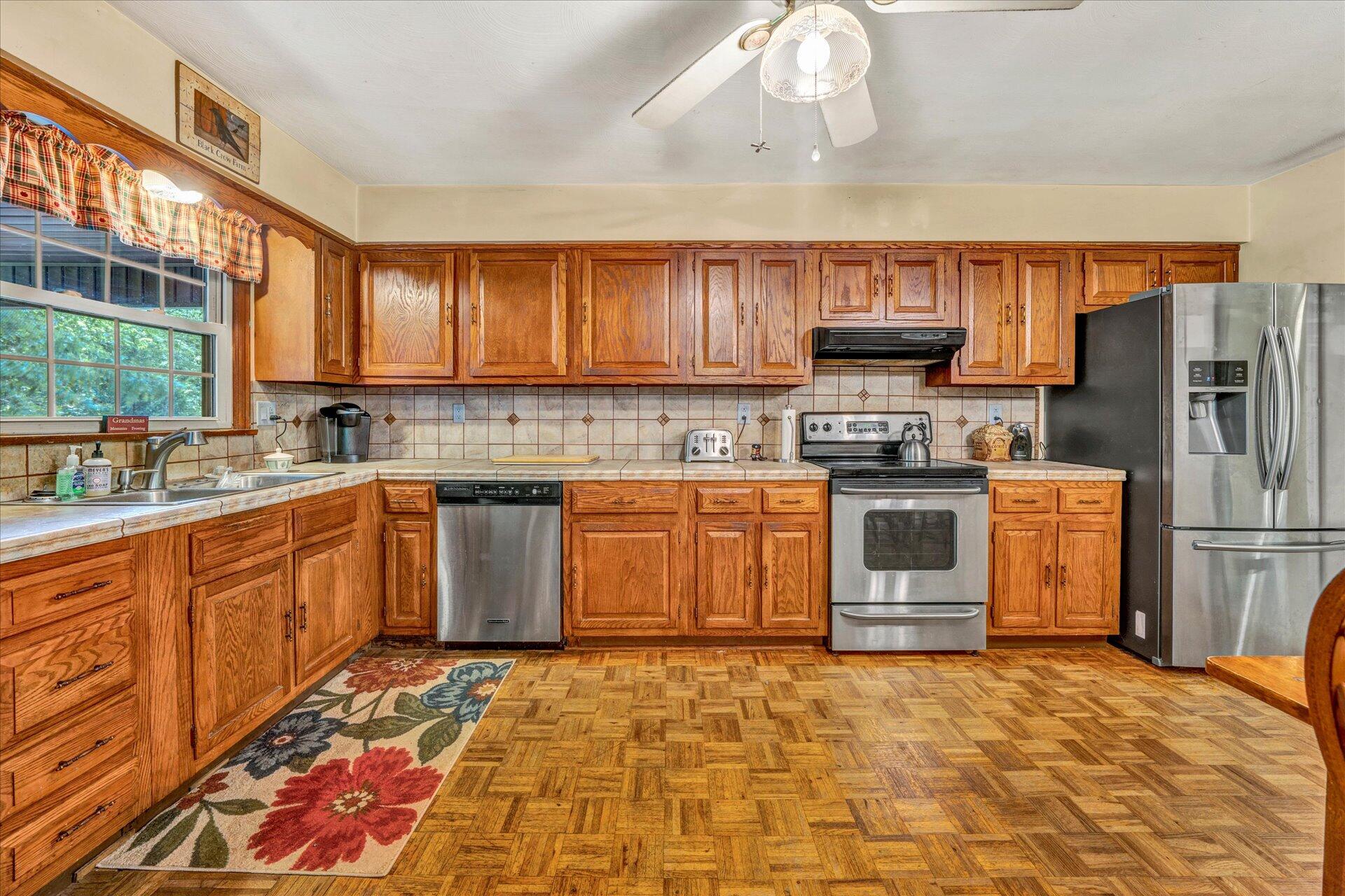 1182 Rabbit Drive Thaxton, VA 24174 - Photo 10 of 58 a kitchen with stainless steel appliances granite countertop a stove a sink dishwasher and a refrigerator