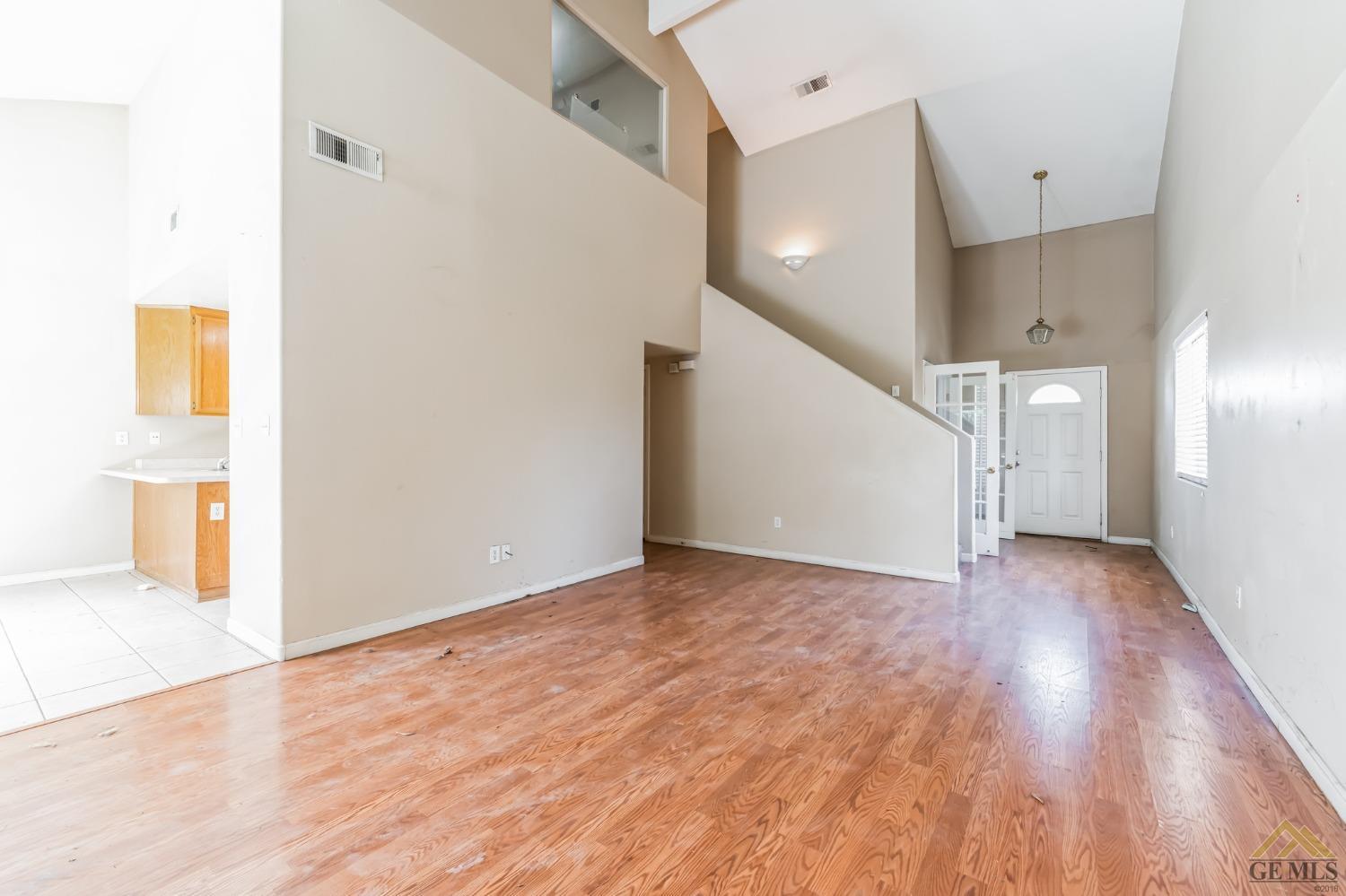 Undisclosed Address Bakersfield, CA 93307 - Photo 5 of 6 a view of an empty room with wooden floor