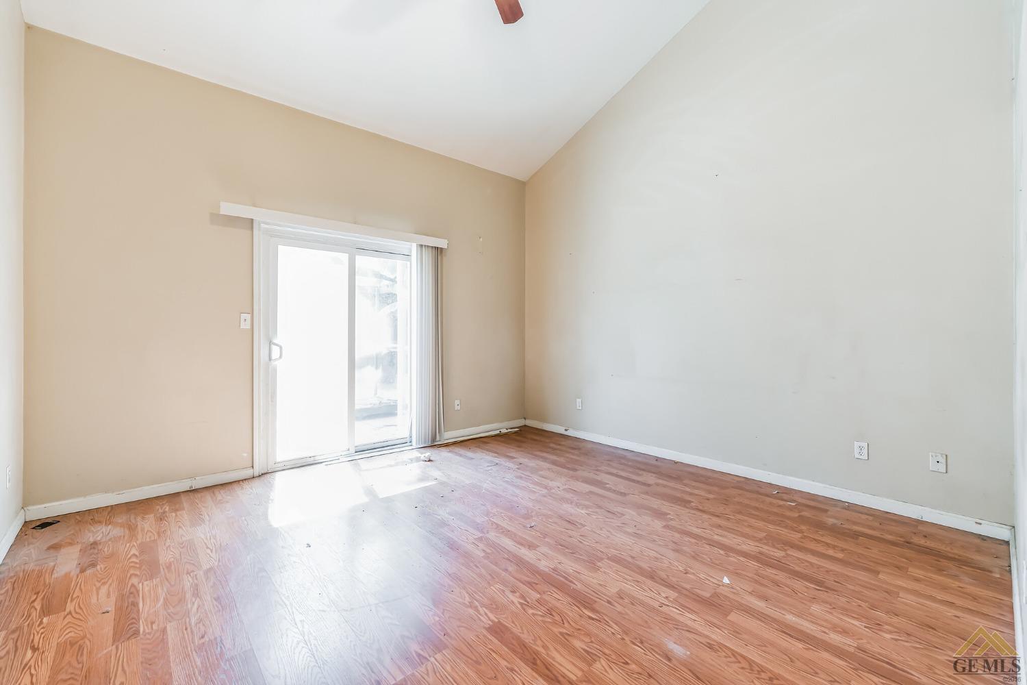 Undisclosed Address Bakersfield, CA 93307 - Photo 6 of 6 an empty room with wooden floor and windows