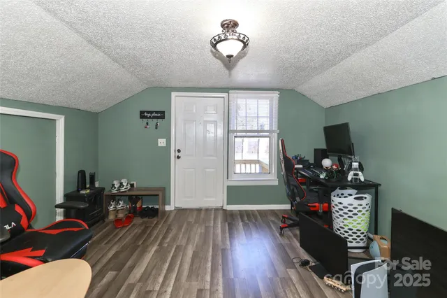a view of a room with furniture and wooden floor