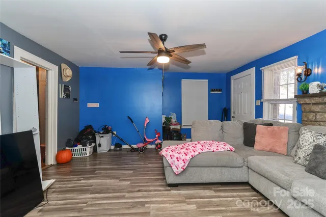a living room with furniture a flat screen tv and a window