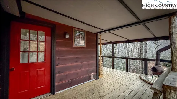 a bedroom with a bed a dresser next to a large window