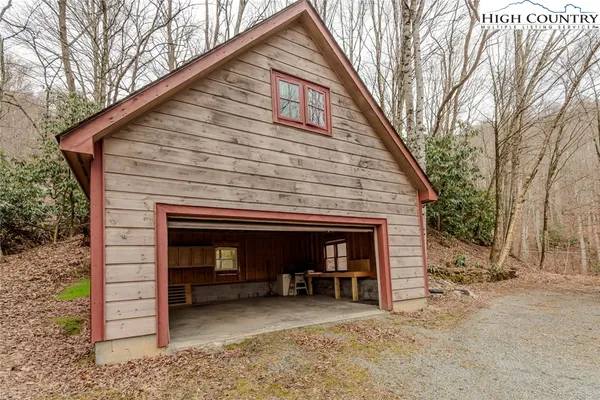 a view of a house with a yard and garage