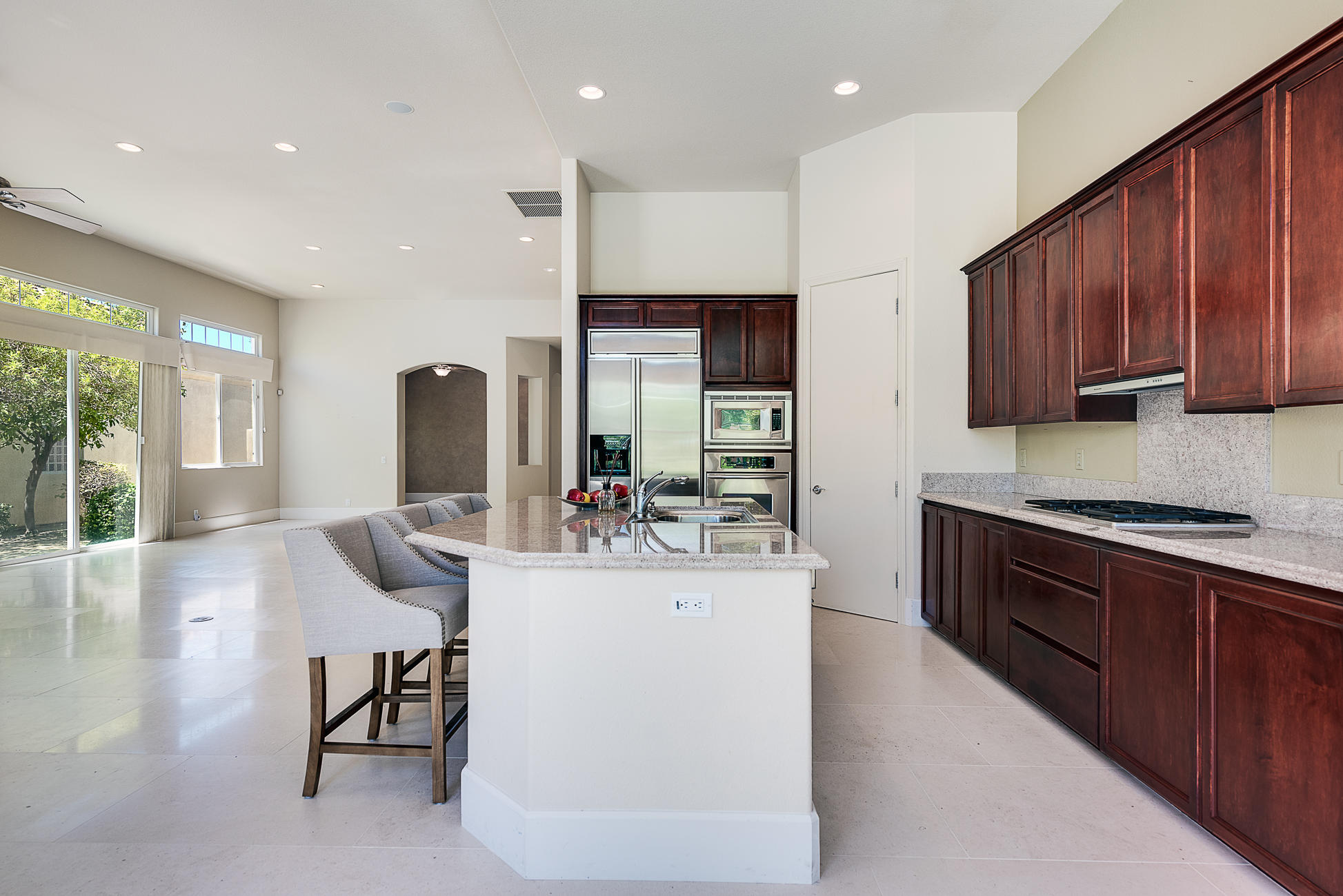 20 Vía Bella Rancho Mirage, CA 92270 - Photo 15 of 26 a kitchen with stainless steel appliances granite countertop a sink stove and refrigerator