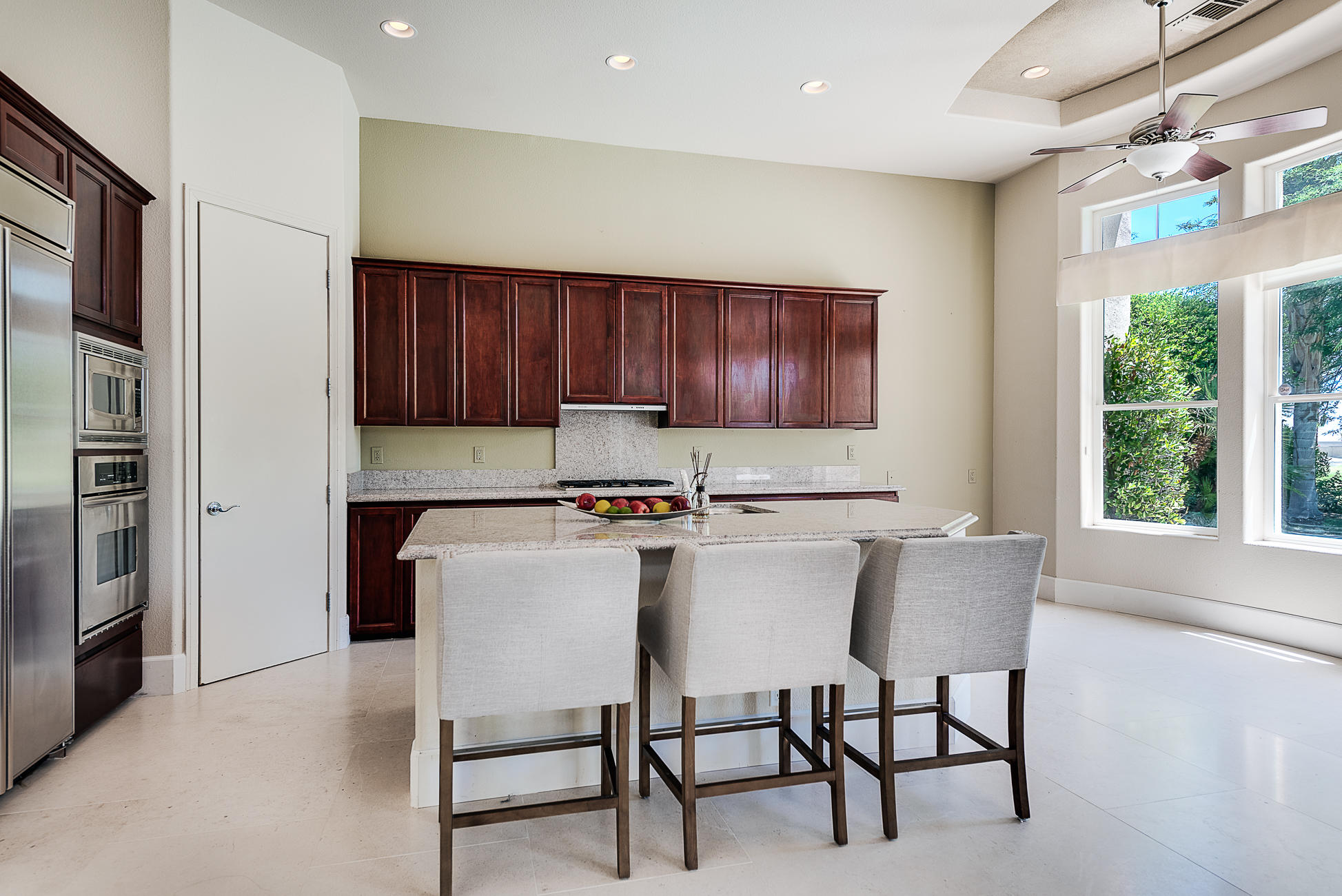20 Vía Bella Rancho Mirage, CA 92270 - Photo 16 of 26 a kitchen with a table chairs refrigerator and microwave