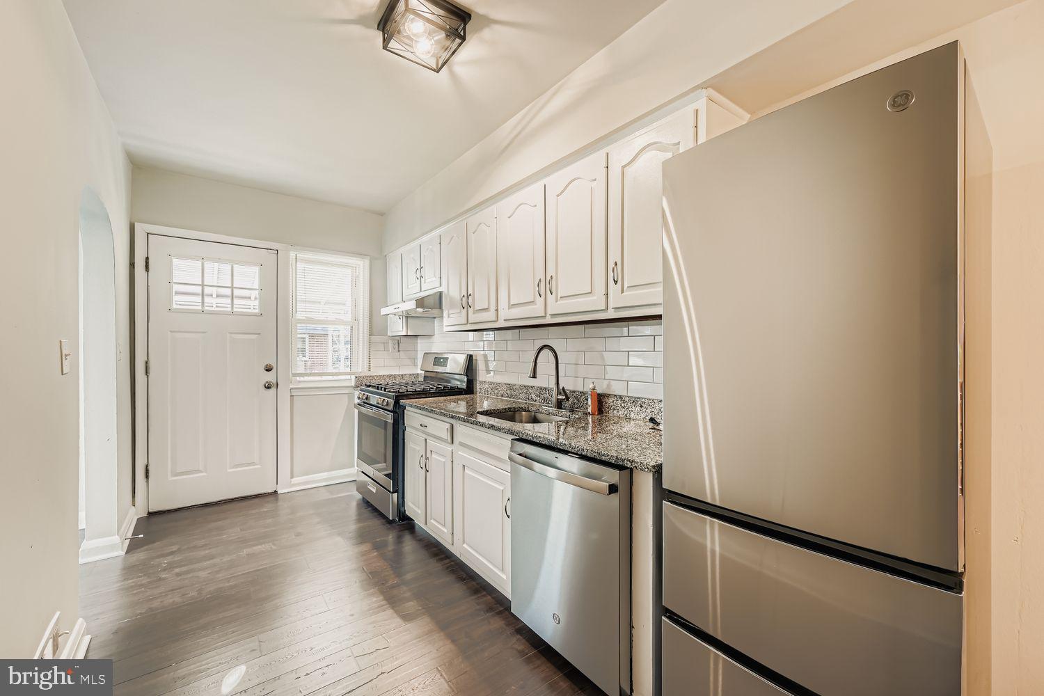 3711 Ina Avenue Baltimore, MD 21206 - Photo 12 of 29 a kitchen with white cabinets and white appliances