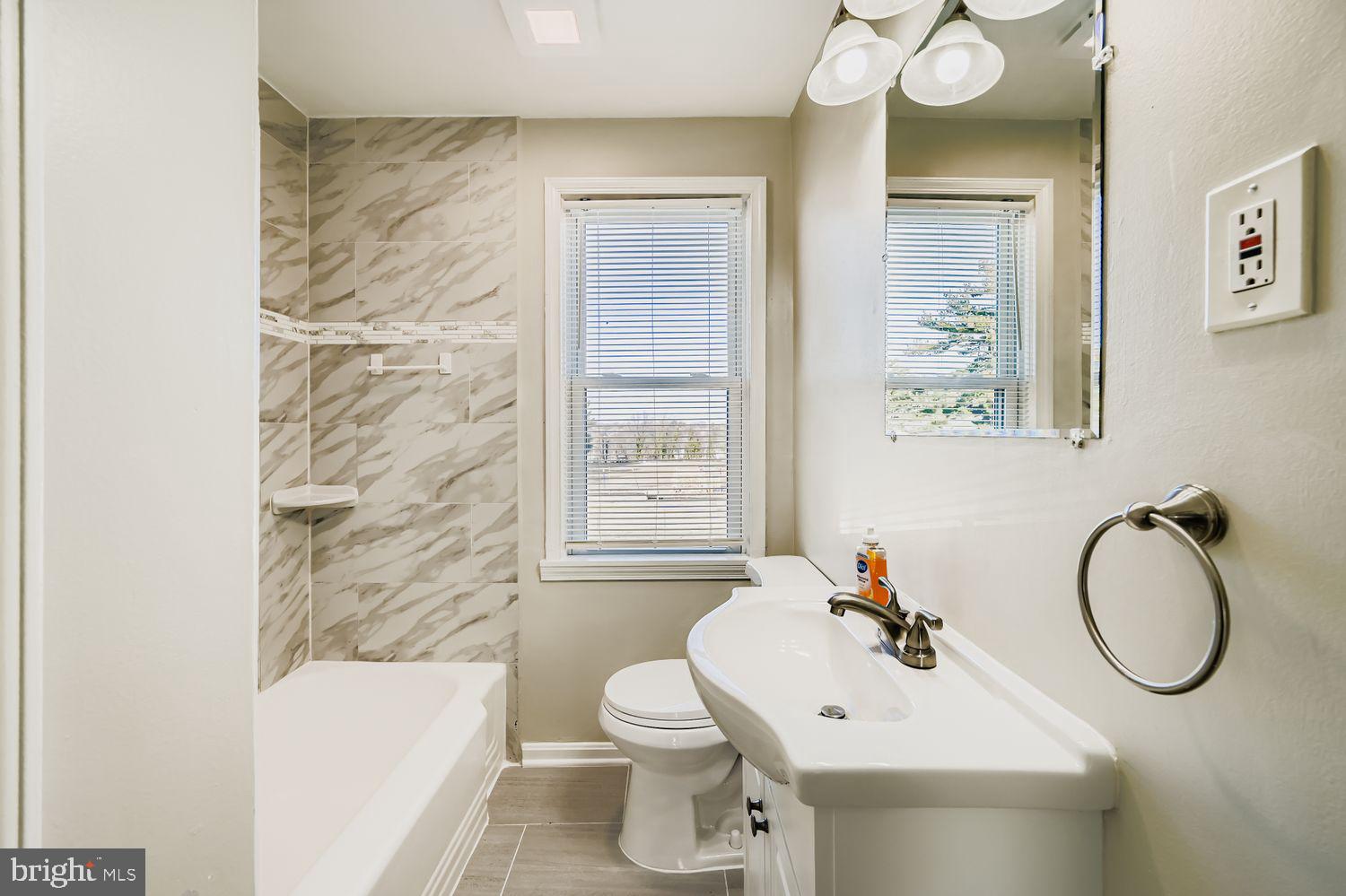 3711 Ina Avenue Baltimore, MD 21206 - Photo 16 of 29 a bathroom with a sink toilet and shower